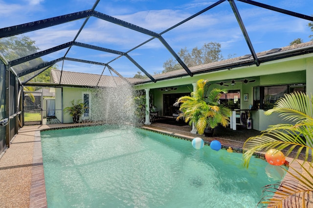 view of pool with pool water feature, a patio area, ceiling fan, and a lanai