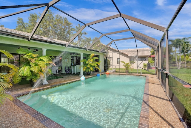 view of pool featuring ceiling fan and a lanai