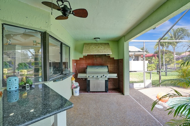 view of patio with ceiling fan, grilling area, and glass enclosure