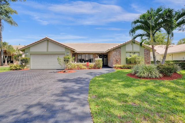 single story home featuring a garage and a front yard