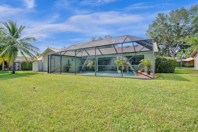 back of property with a lawn and glass enclosure