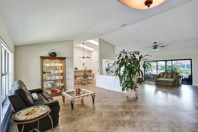 living area featuring ceiling fan and vaulted ceiling