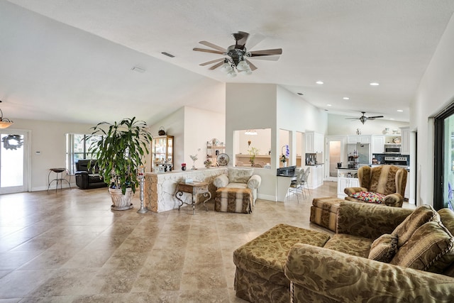 living room with high vaulted ceiling and ceiling fan