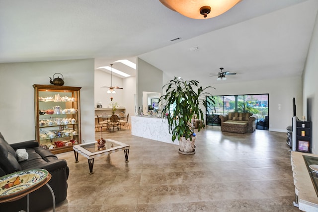 living room featuring ceiling fan and vaulted ceiling