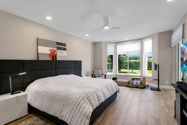 bedroom with hardwood / wood-style floors and ceiling fan