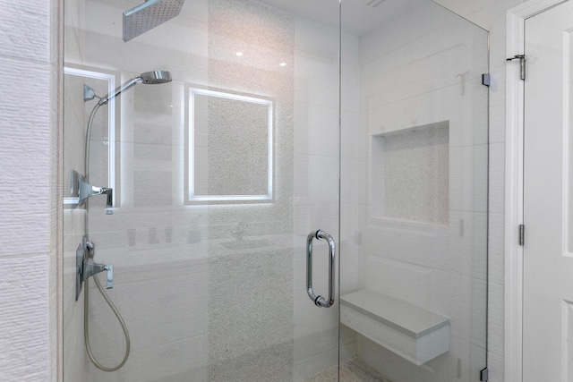 bathroom featuring a shower with door