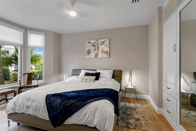 bedroom with ceiling fan and light wood-type flooring