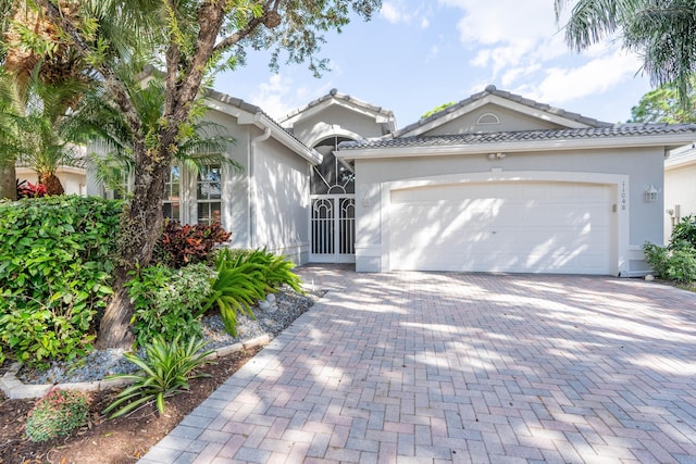 mediterranean / spanish-style home with a garage