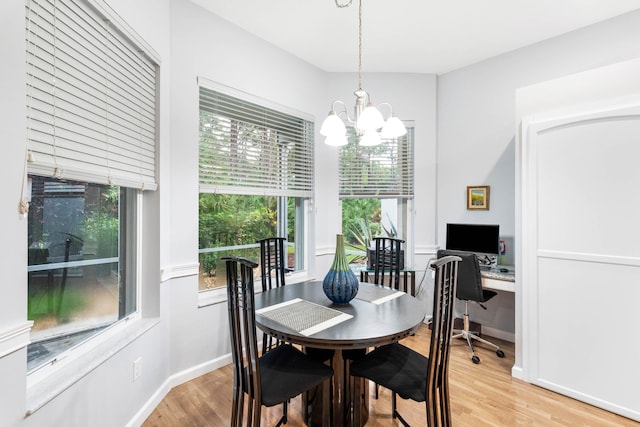 dining area featuring a notable chandelier and light wood-type flooring