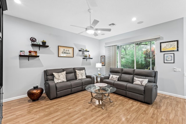 living room featuring ceiling fan and light hardwood / wood-style flooring