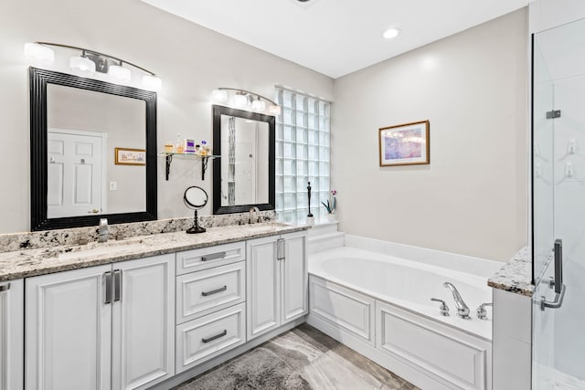 bathroom featuring vanity and separate shower and tub