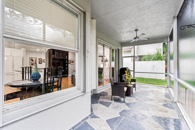 sunroom / solarium with ceiling fan