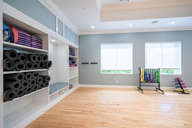 living area featuring hardwood / wood-style flooring and ornamental molding