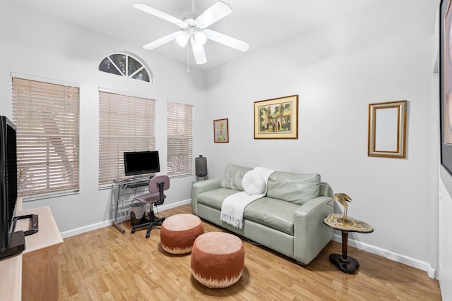 living room featuring ceiling fan and light hardwood / wood-style floors