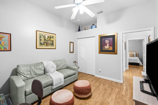 living room with high vaulted ceiling, light hardwood / wood-style flooring, and ceiling fan