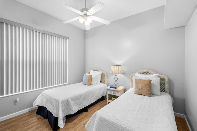 bedroom featuring hardwood / wood-style flooring and ceiling fan