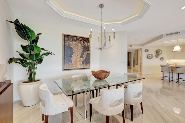 dining space featuring a notable chandelier and a tray ceiling