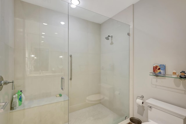 bathroom with a shower with door and toilet