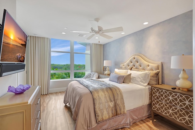 bedroom with ceiling fan and light hardwood / wood-style floors