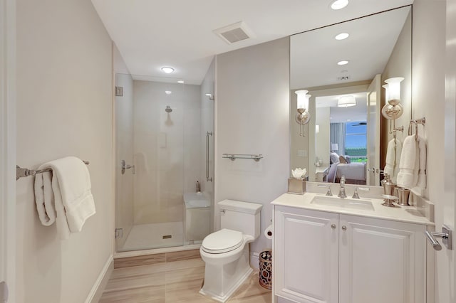 bathroom featuring vanity, toilet, and walk in shower