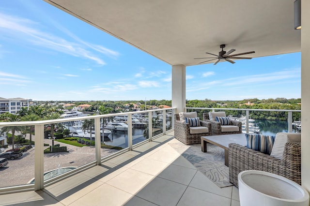 balcony featuring ceiling fan and a water view