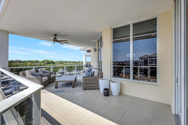 view of patio with ceiling fan, a balcony, and an outdoor living space