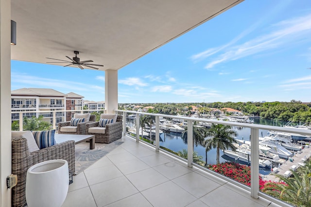 balcony with a water view and an outdoor hangout area