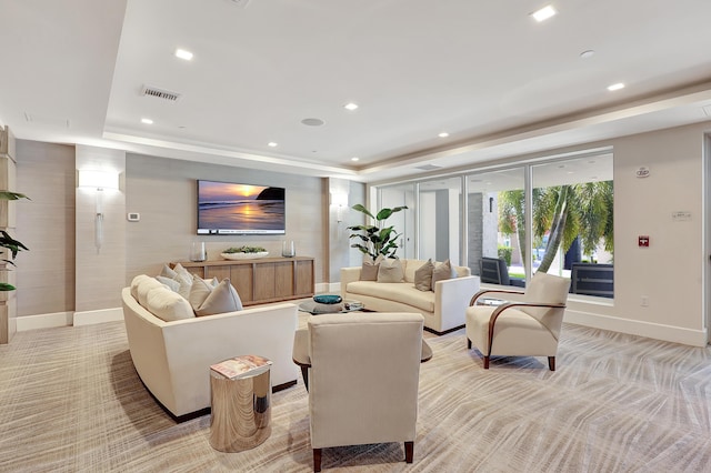 carpeted living room featuring a tray ceiling