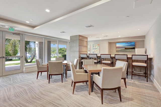 dining space featuring light colored carpet