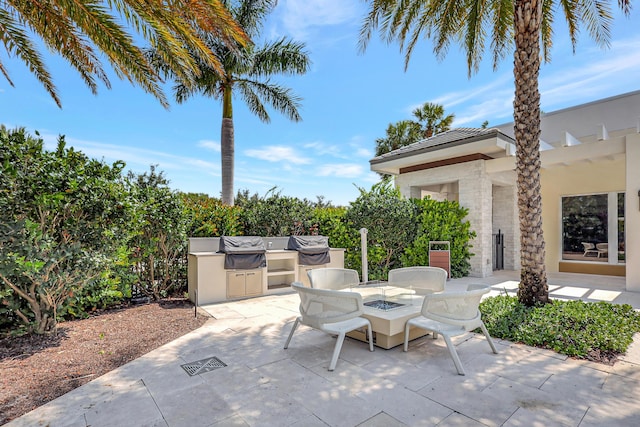 view of patio featuring area for grilling and an outdoor fire pit