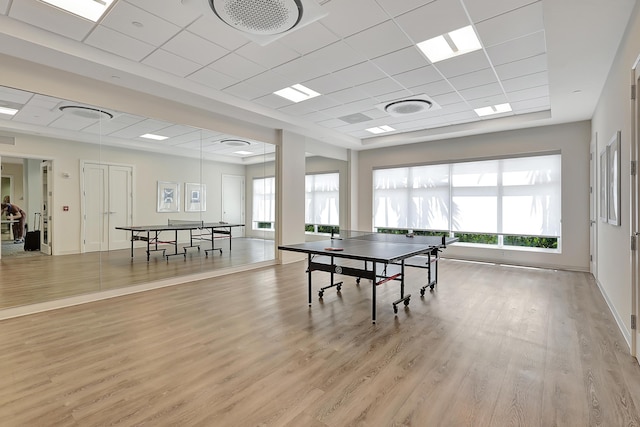 rec room featuring a drop ceiling and light hardwood / wood-style floors