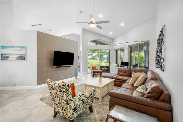 tiled living room featuring ceiling fan, a fireplace, and high vaulted ceiling