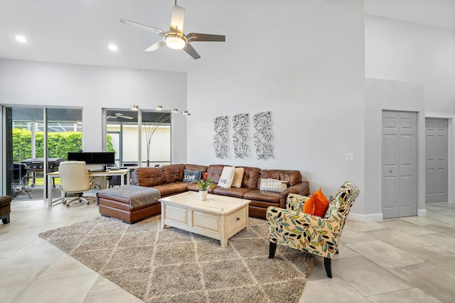 living room featuring light tile patterned floors, high vaulted ceiling, and ceiling fan