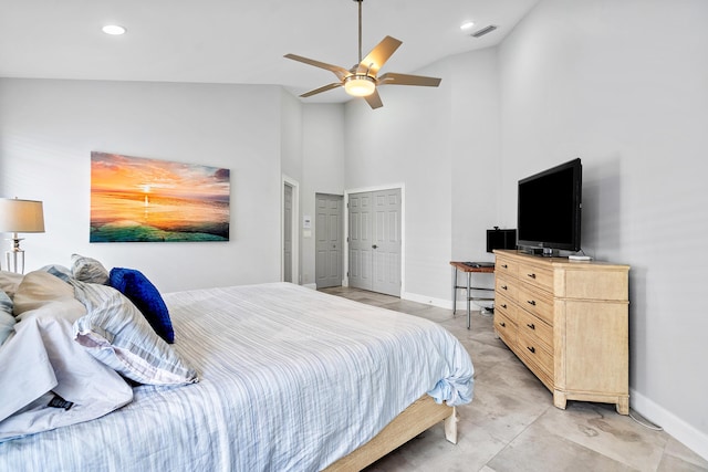 bedroom with ceiling fan and high vaulted ceiling