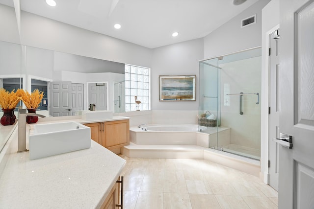 bathroom with tile patterned floors, vanity, and shower with separate bathtub