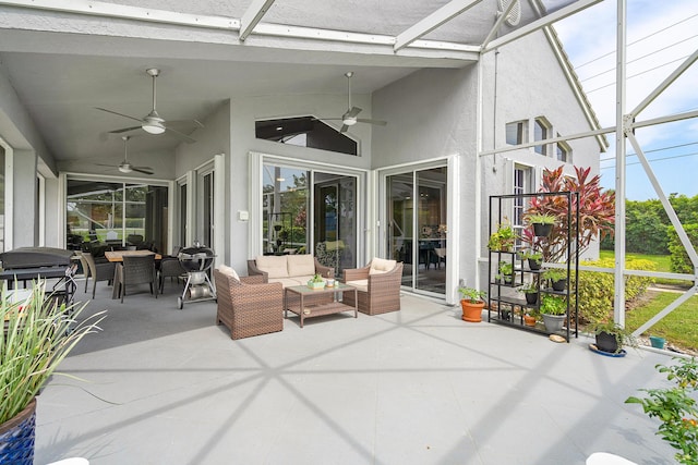 sunroom with ceiling fan and lofted ceiling