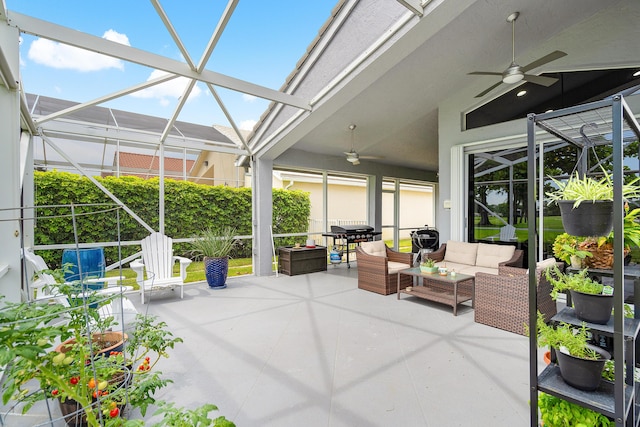 view of patio / terrace featuring outdoor lounge area, ceiling fan, and glass enclosure