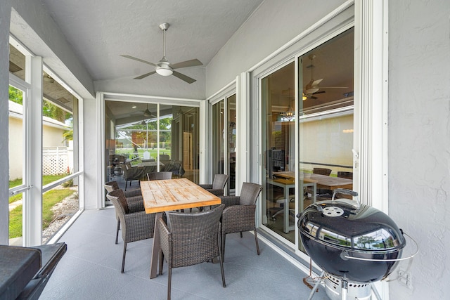 sunroom featuring ceiling fan and vaulted ceiling