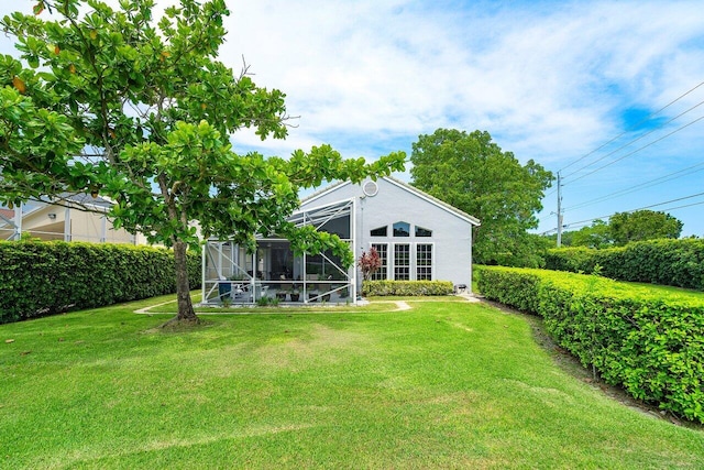 view of yard featuring glass enclosure