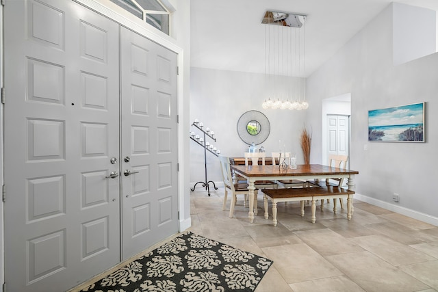 tiled entryway with high vaulted ceiling