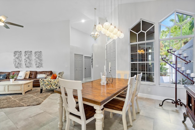 dining area featuring light tile patterned floors, high vaulted ceiling, and ceiling fan