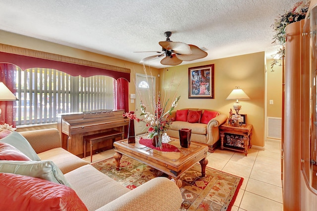 tiled living room with ceiling fan and a textured ceiling