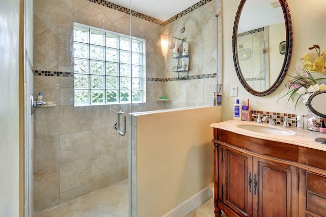 bathroom featuring a shower with door, vanity, and a healthy amount of sunlight