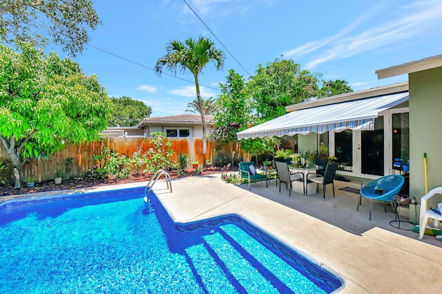 view of pool featuring french doors and a patio area