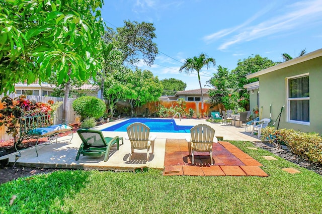 view of swimming pool with a patio area and a lawn