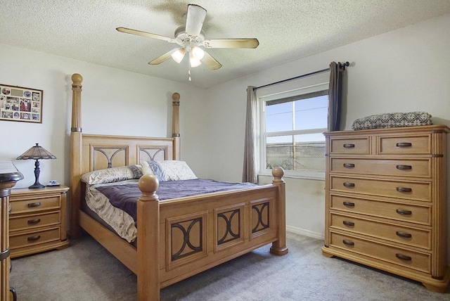 bedroom featuring carpet, ceiling fan, and a textured ceiling