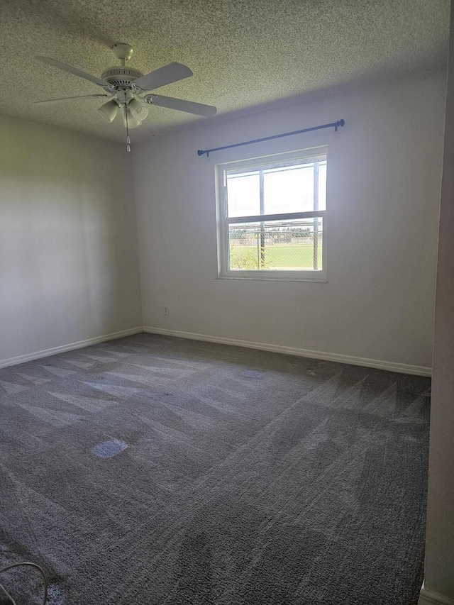 carpeted spare room with ceiling fan and a textured ceiling