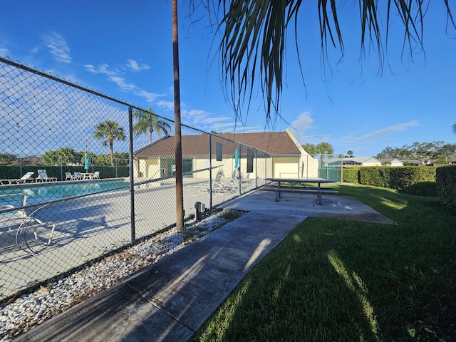 view of pool with a lawn