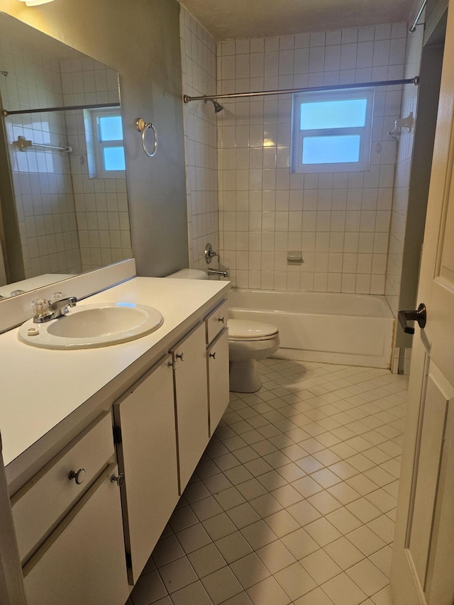 full bathroom with toilet, vanity, tile patterned floors, and tiled shower / bath combo