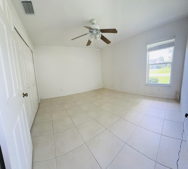 empty room featuring light tile patterned floors and ceiling fan